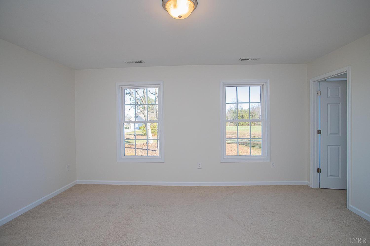 2417 River Road Madison Heights, VA 24572 - Photo 16 of 35 an empty room with windows and closet