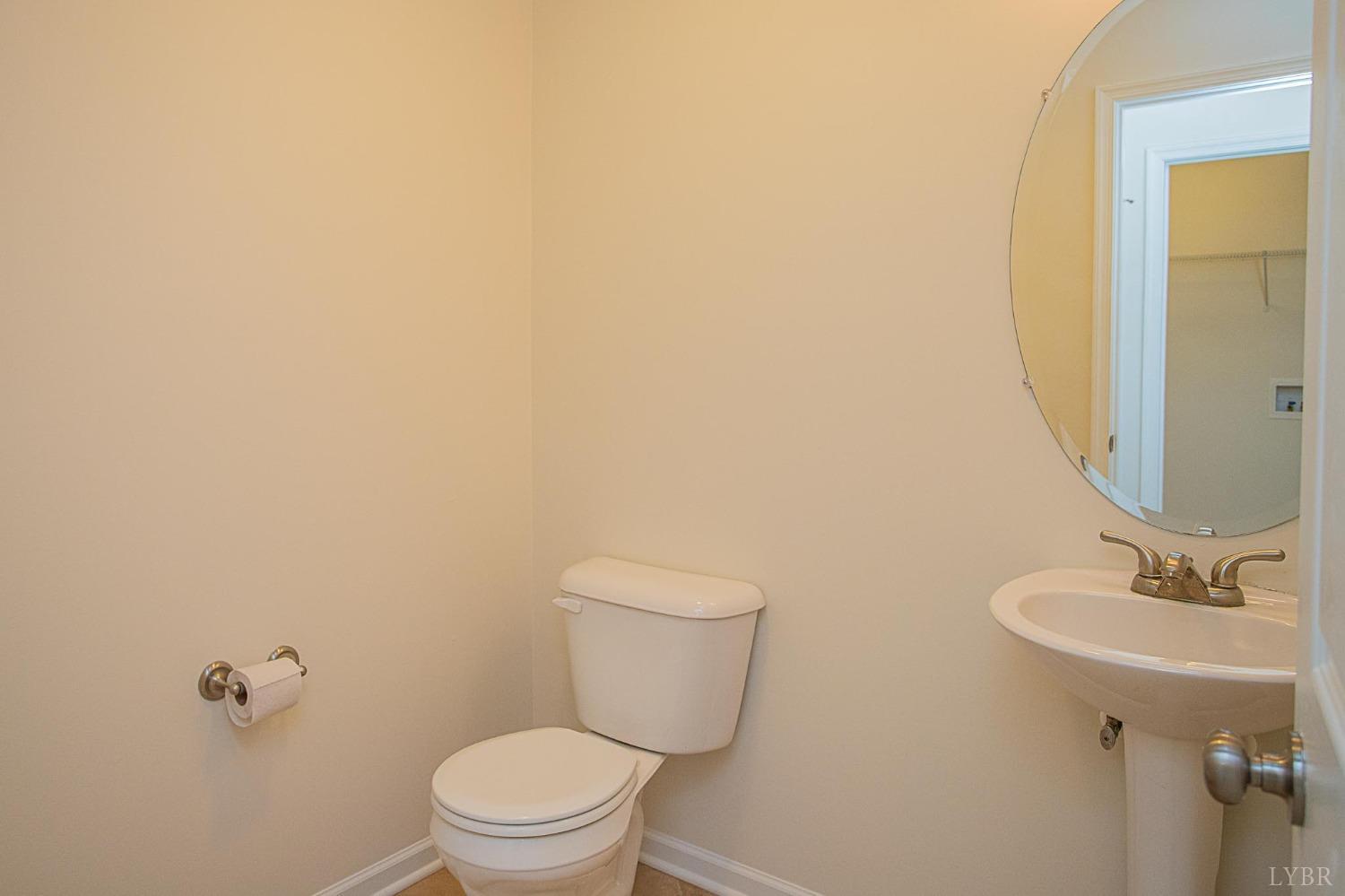 2417 River Road Madison Heights, VA 24572 - Photo 17 of 35 a bathroom with a toilet a sink and mirror