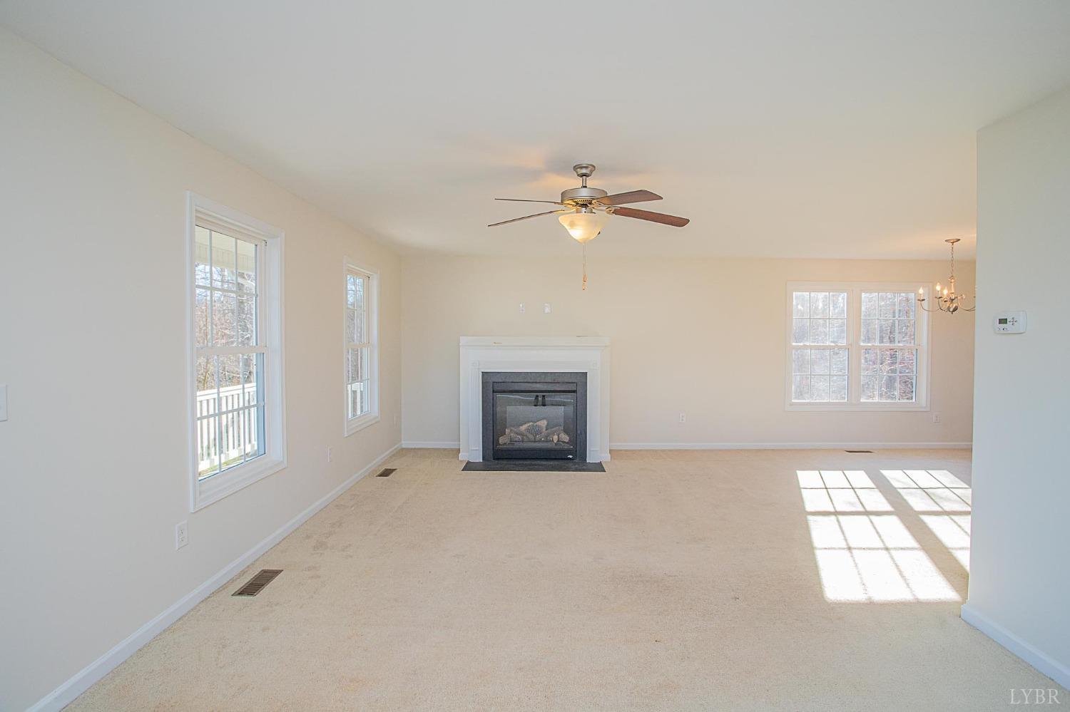 2417 River Road Madison Heights, VA 24572 - Photo 19 of 35 an empty room with windows and ceiling fan