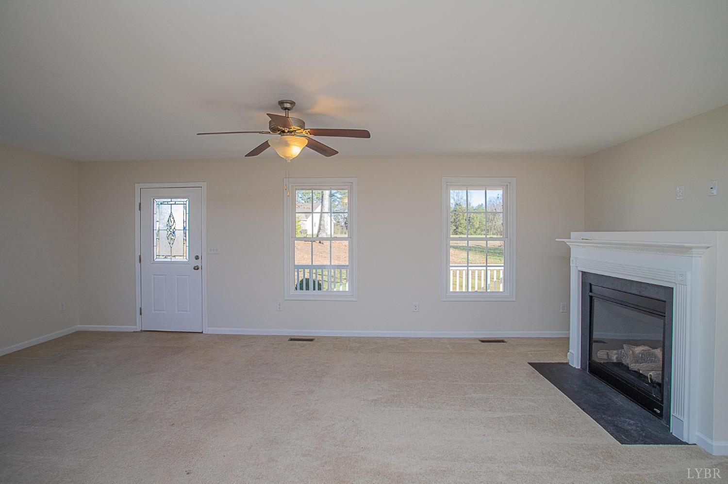 2417 River Road Madison Heights, VA 24572 - Photo 20 of 35 an empty room with chandelier fan and windows