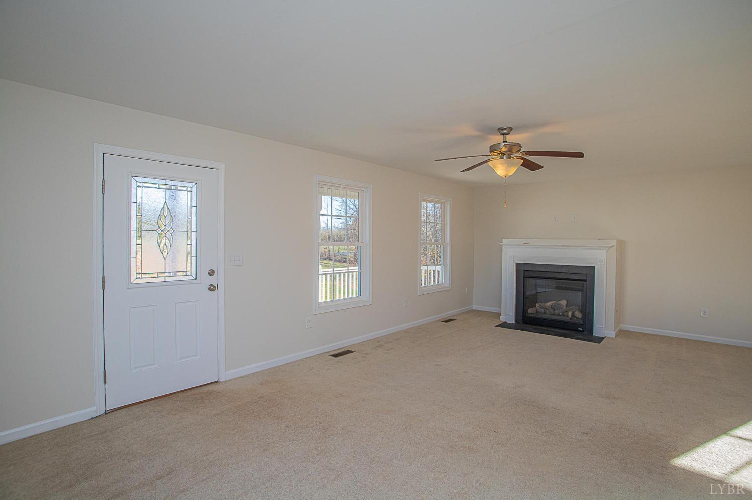 2417 River Road Madison Heights, VA 24572 - Photo 21 of 35 an empty room with windows and fireplace