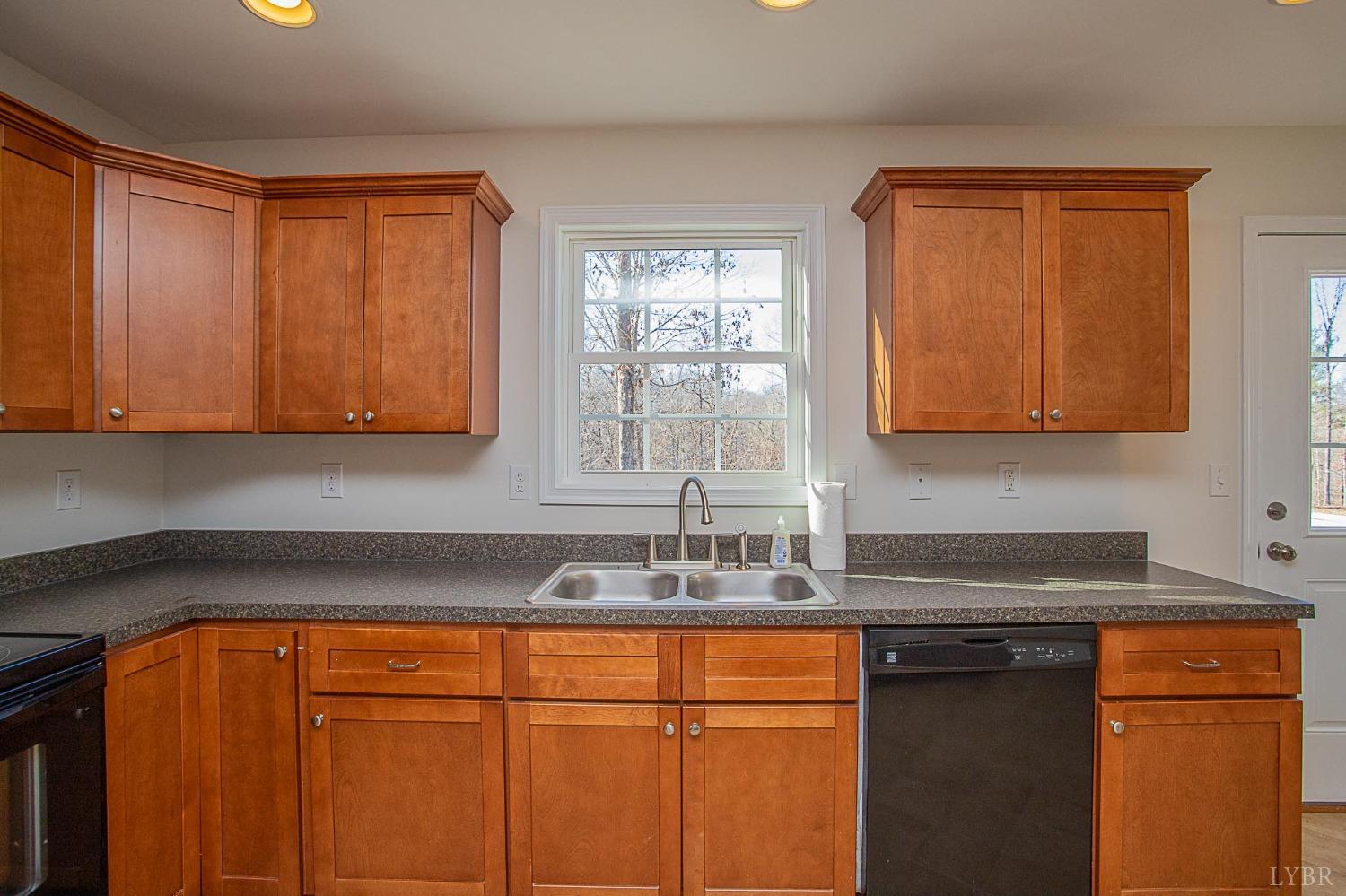2417 River Road Madison Heights, VA 24572 - Photo 24 of 35 a kitchen with stainless steel appliances granite countertop wooden cabinets and a sink