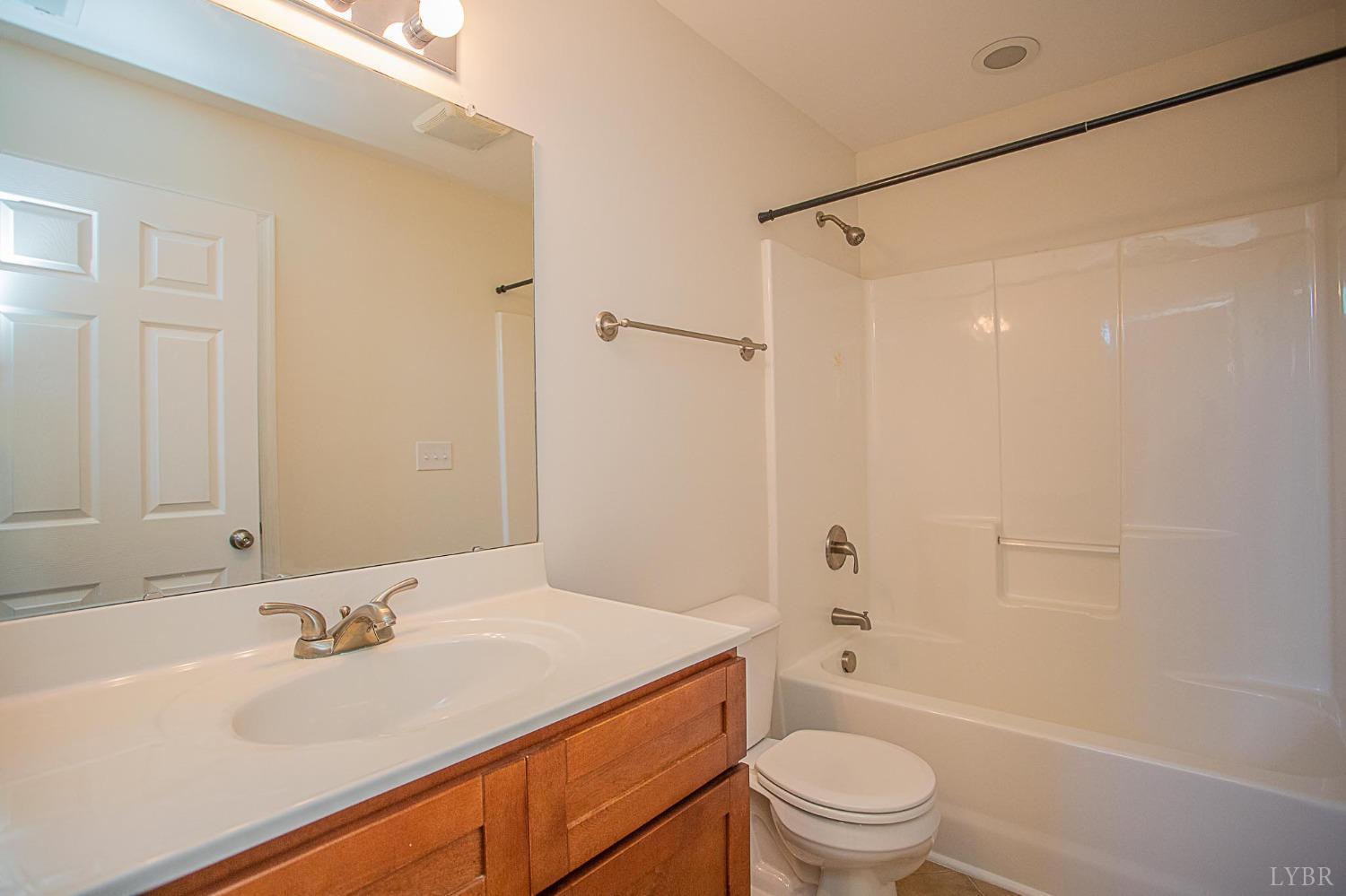 2417 River Road Madison Heights, VA 24572 - Photo 8 of 35 a bathroom with a sink a toilet and shower