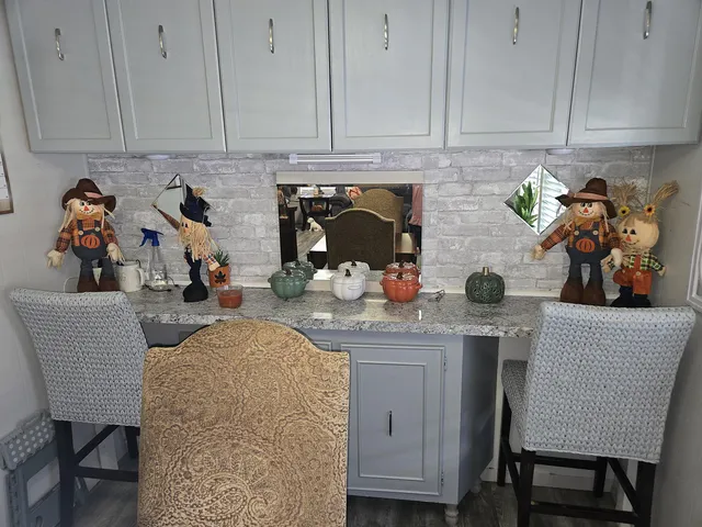 a kitchen with stainless steel appliances granite countertop a refrigerator a stove and a sink