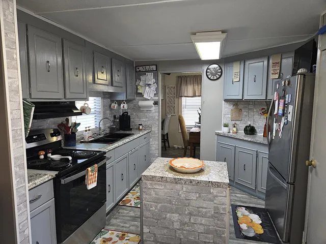 a living room with furniture a rug and a flat screen tv