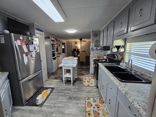 a living room with furniture a dining table and chairs with wooden floor