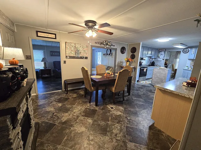 a living room with furniture a chandelier and a window