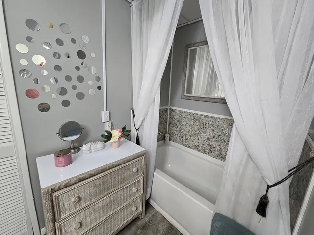 a view of a house with a big yard and a large tree