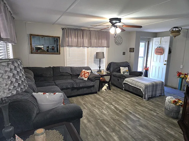 a kitchen with stainless steel appliances white cabinets and wooden floor