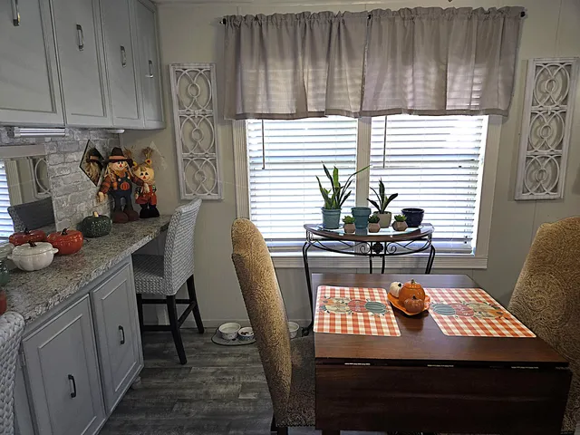 a kitchen with granite countertop a refrigerator stove and cabinets