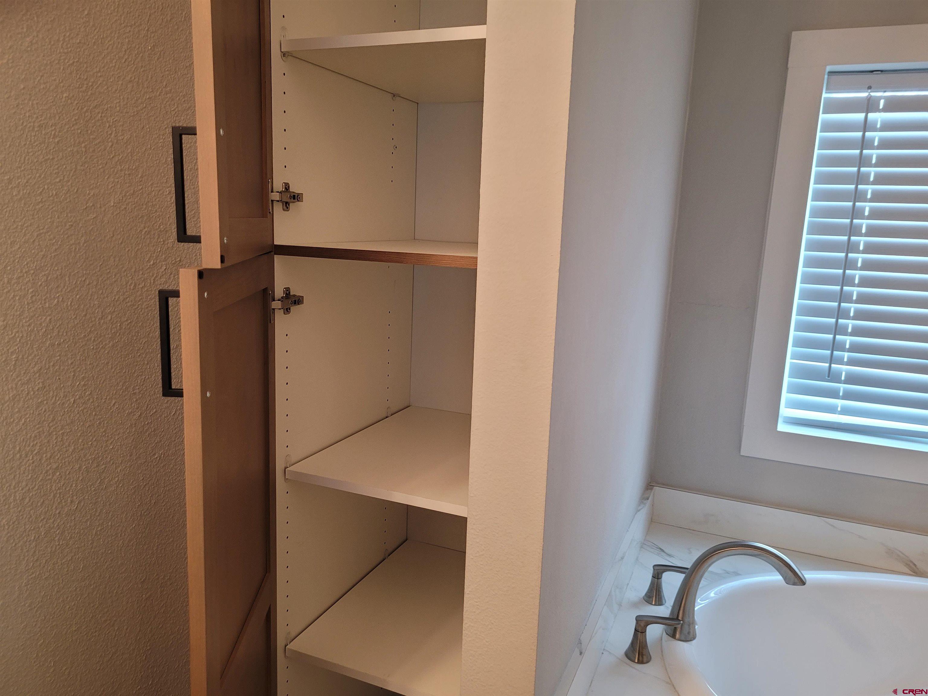 305 9th Street Saguache, CO 81149 - Photo 12 of 32 a bathroom with a bathtub and a window
