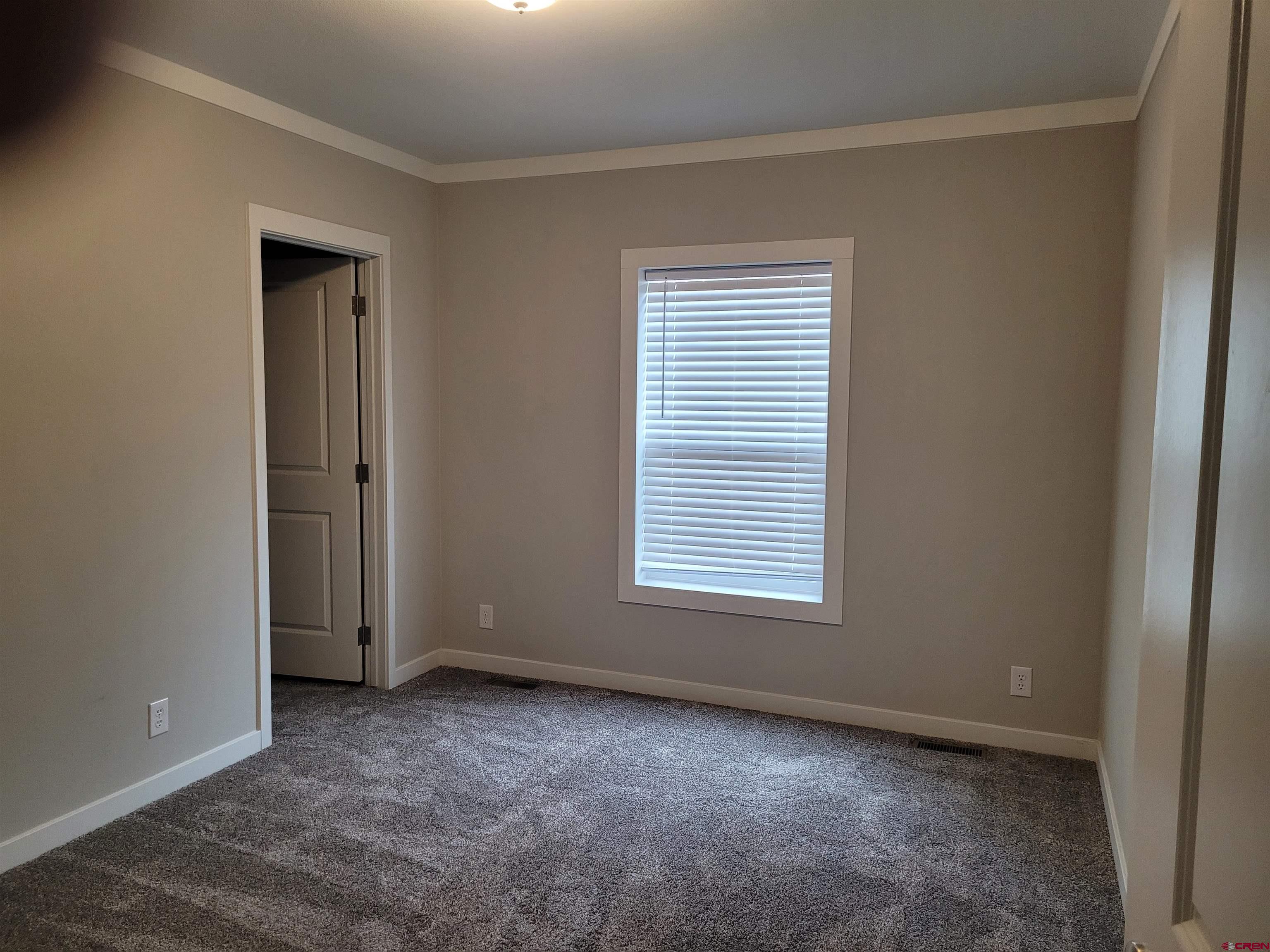 305 9th Street Saguache, CO 81149 - Photo 13 of 32 an empty room with a window and closet