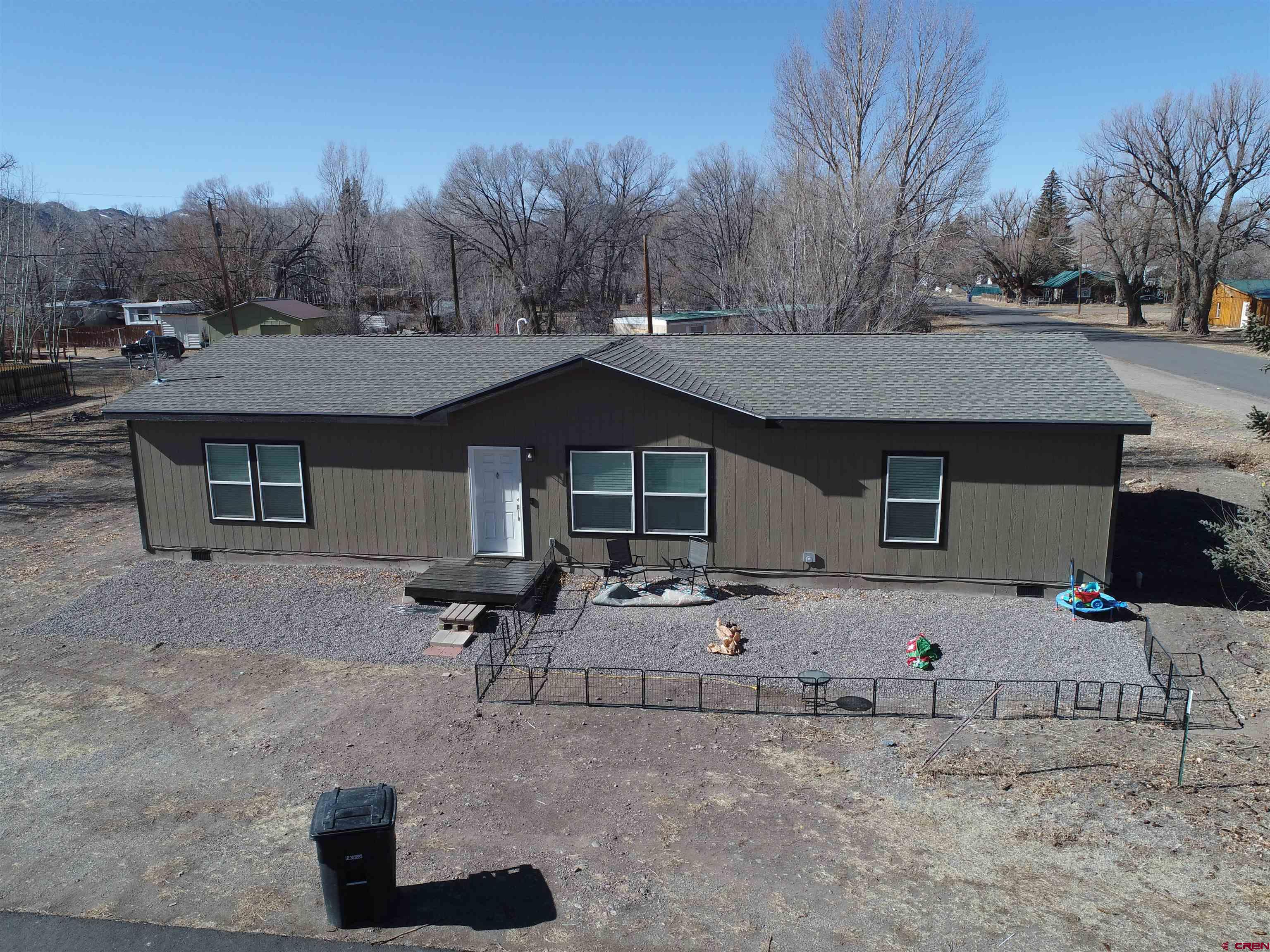 305 9th Street Saguache, CO 81149 - Photo 30 of 32 a front view of a house with a yard and garage