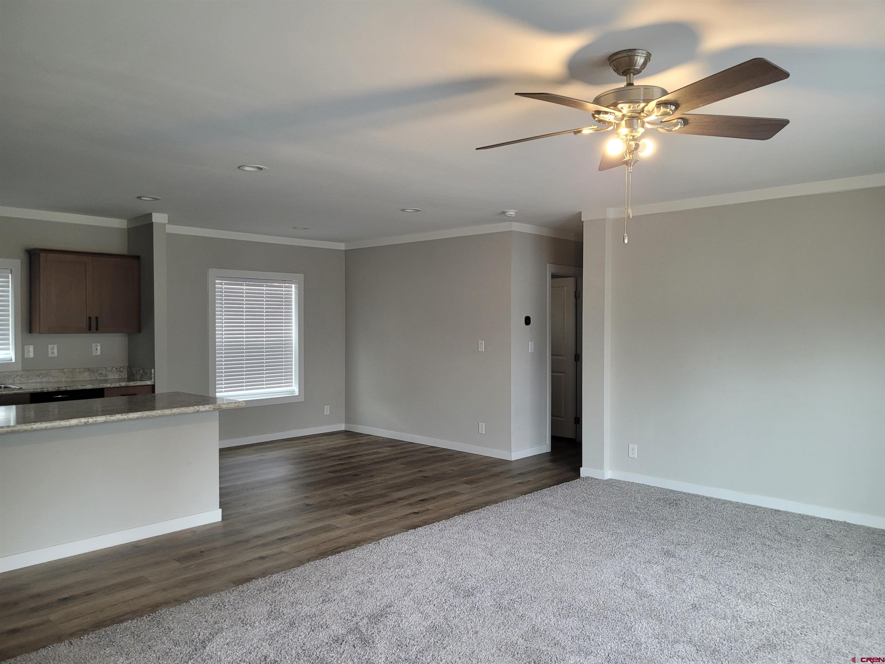 305 9th Street Saguache, CO 81149 - Photo 3 of 32 a view of an empty room with window and wooden floor