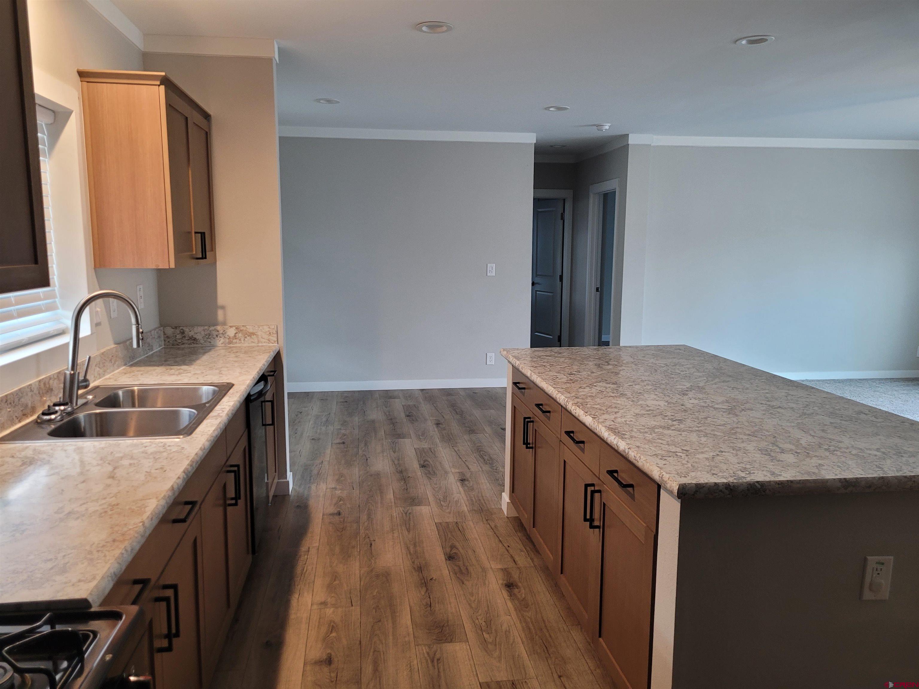 305 9th Street Saguache, CO 81149 - Photo 5 of 32 a kitchen with a sink stove and cabinets