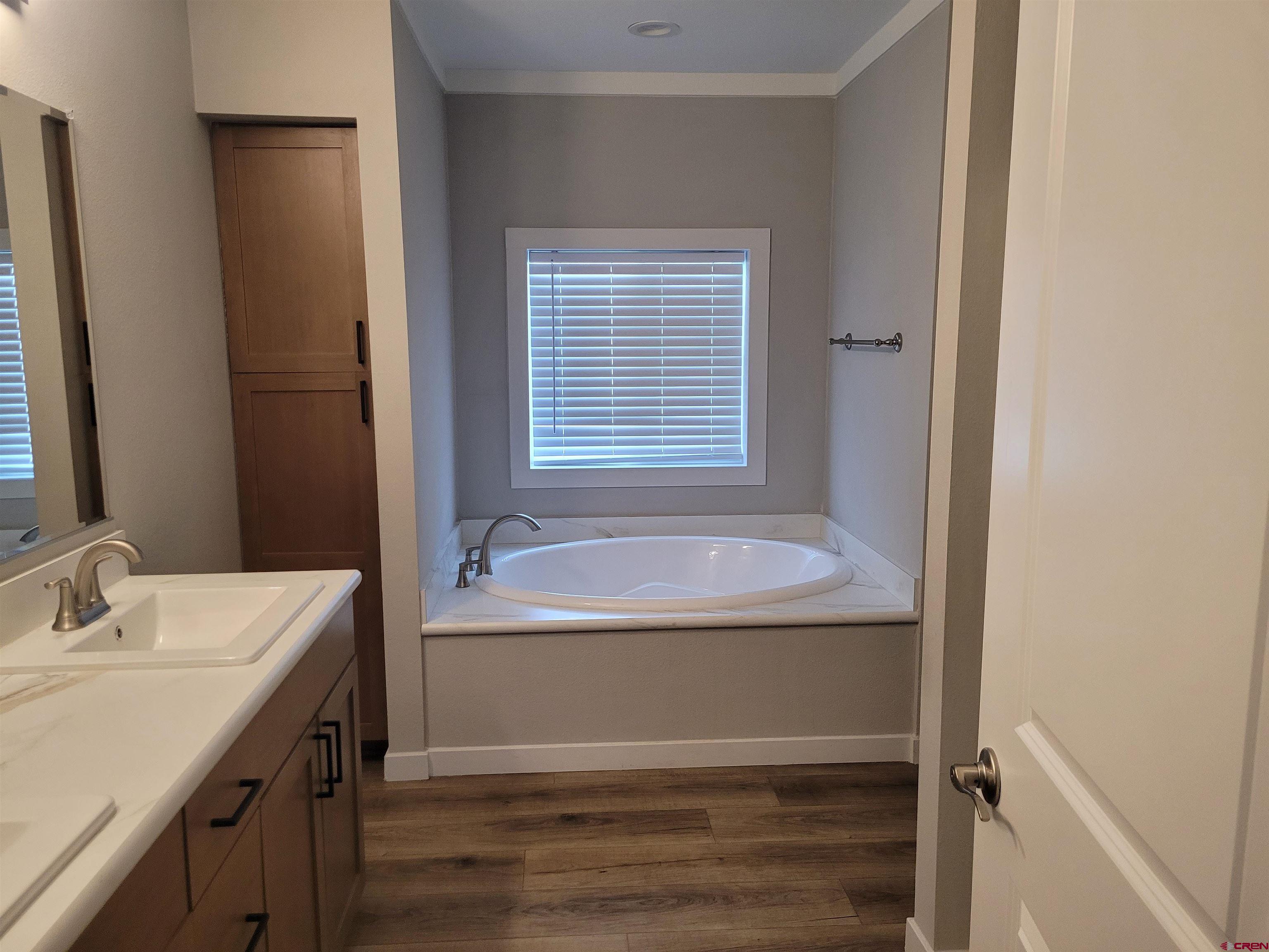 305 9th Street Saguache, CO 81149 - Photo 7 of 32 a bathroom with a tub sink and mirror