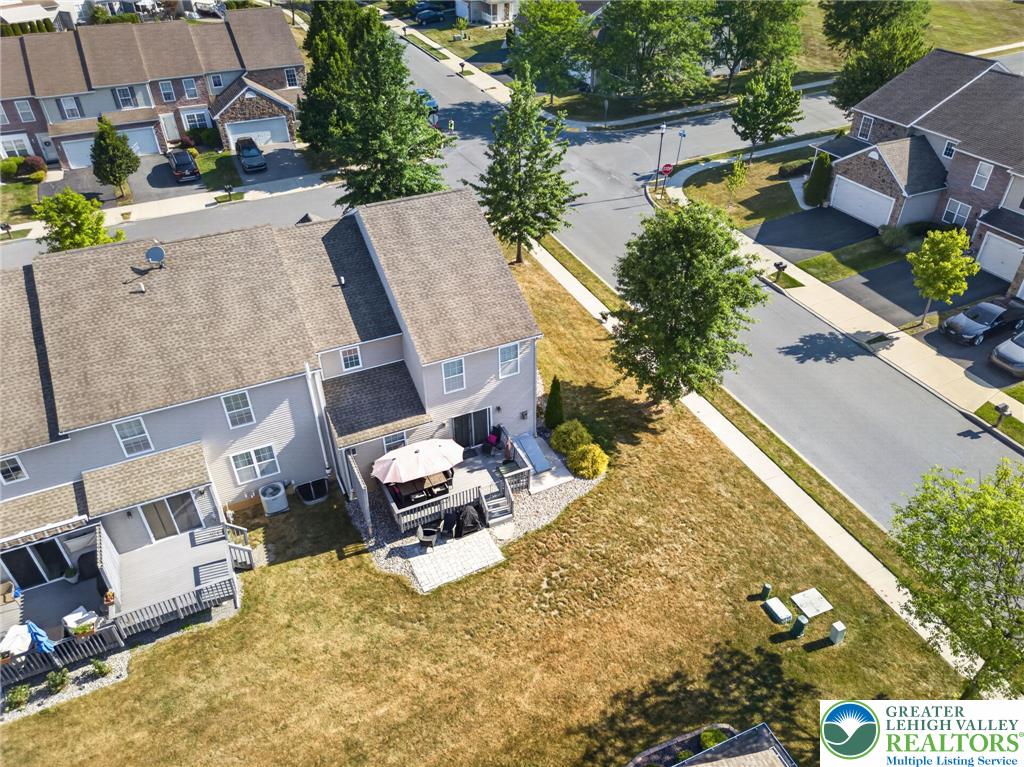 4148 Ross Road Bethlehem, PA 18020 - Photo 8 of 67 An aerial perspective reveals a cozy patio with an umbrella-shaded dining area and a verdant yard, extending to a quiet street.