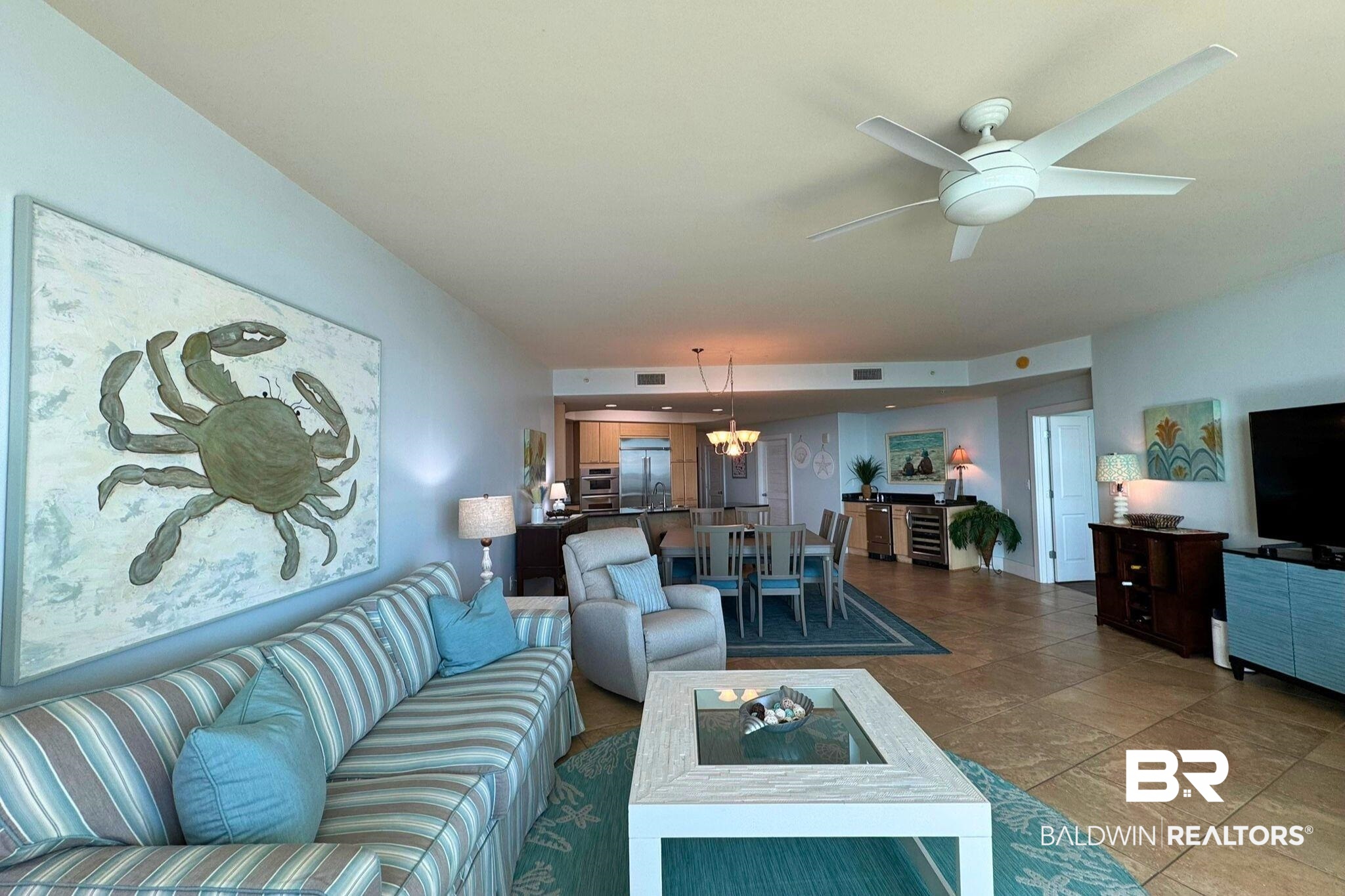 28107 Perdido Beach Boulevard, Unit D714 Orange Beach, AL 36561 - Photo 7 of 88 Living room featuring visible vents and ceiling fan with notable chandelier