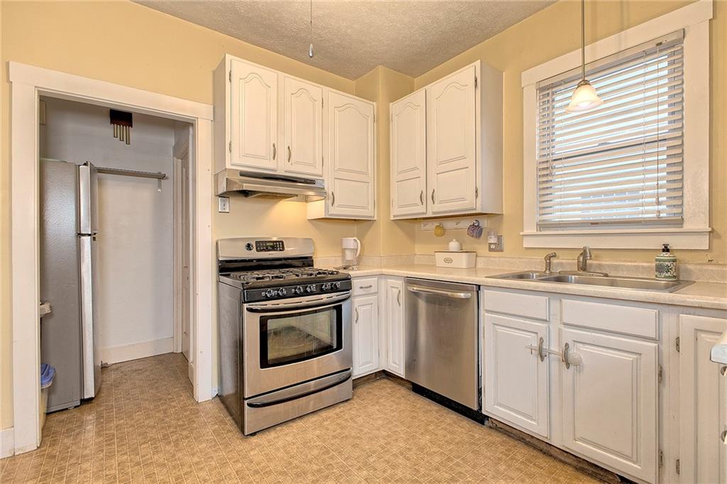 771 6th Street Beaver, PA 15009 - Photo 12 of 28 a kitchen with white cabinets and white appliances