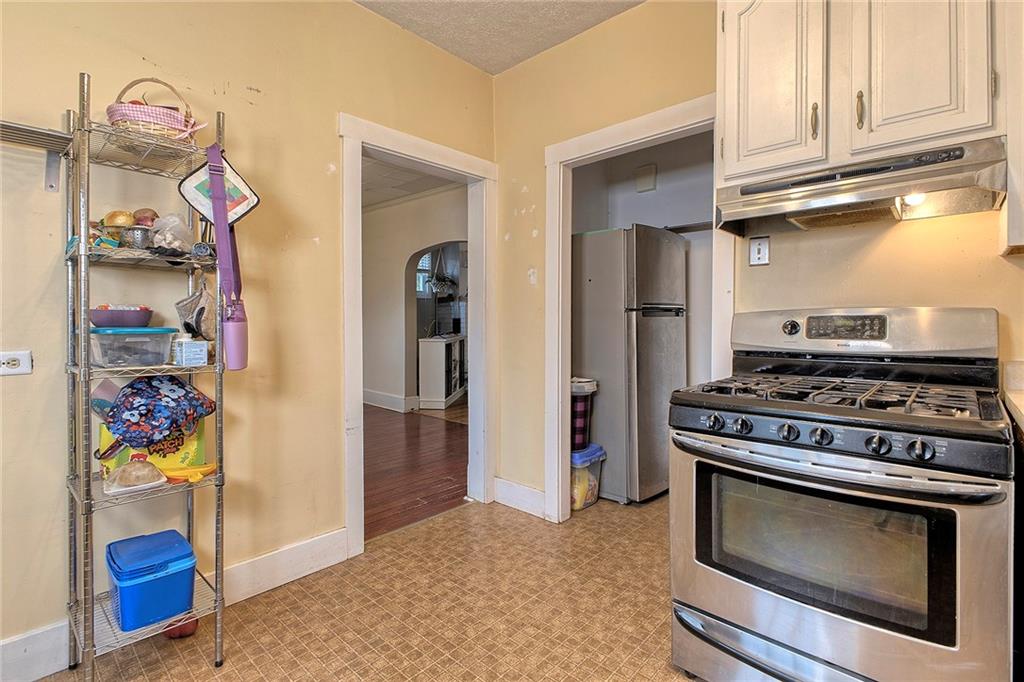771 6th Street Beaver, PA 15009 - Photo 10 of 28 a kitchen with stainless steel appliances granite countertop a stove and a refrigerator