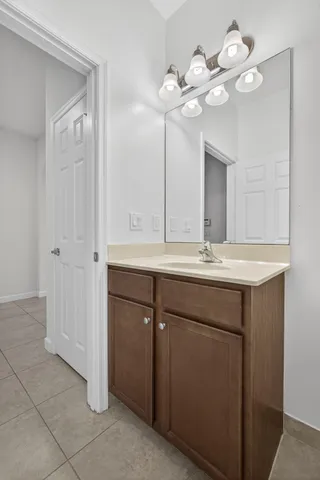 a bathroom with a sink a mirror and a light fixture