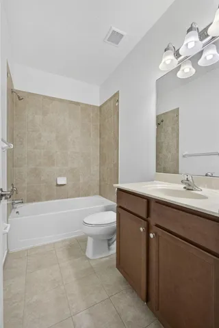 a bathroom with a sink a toilet and bathtub