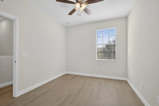 wooden floor in an empty room with a window