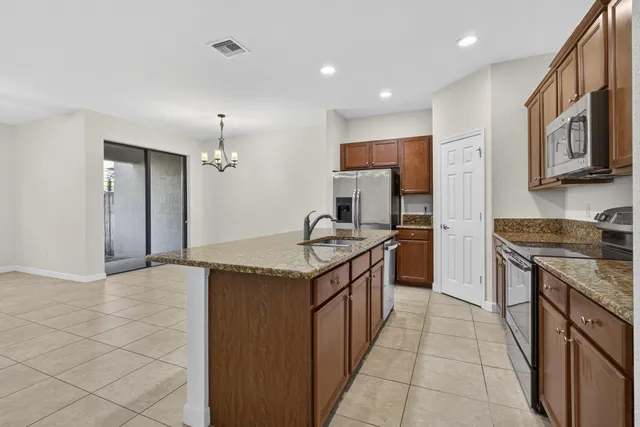 a kitchen with granite countertop a sink and a stove