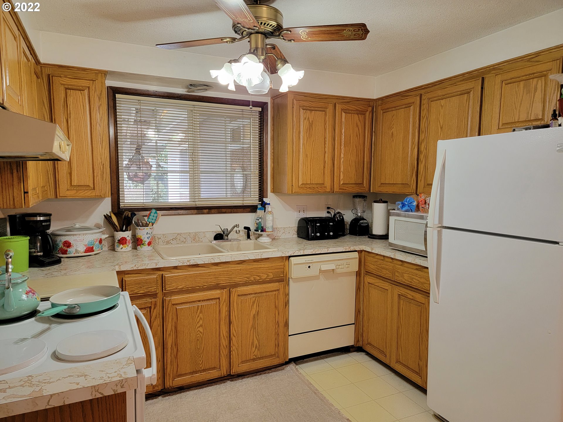 2287 8th Street Springfield, OR 97477 - Photo 3 of 18 a kitchen with a sink a refrigerator and cabinets