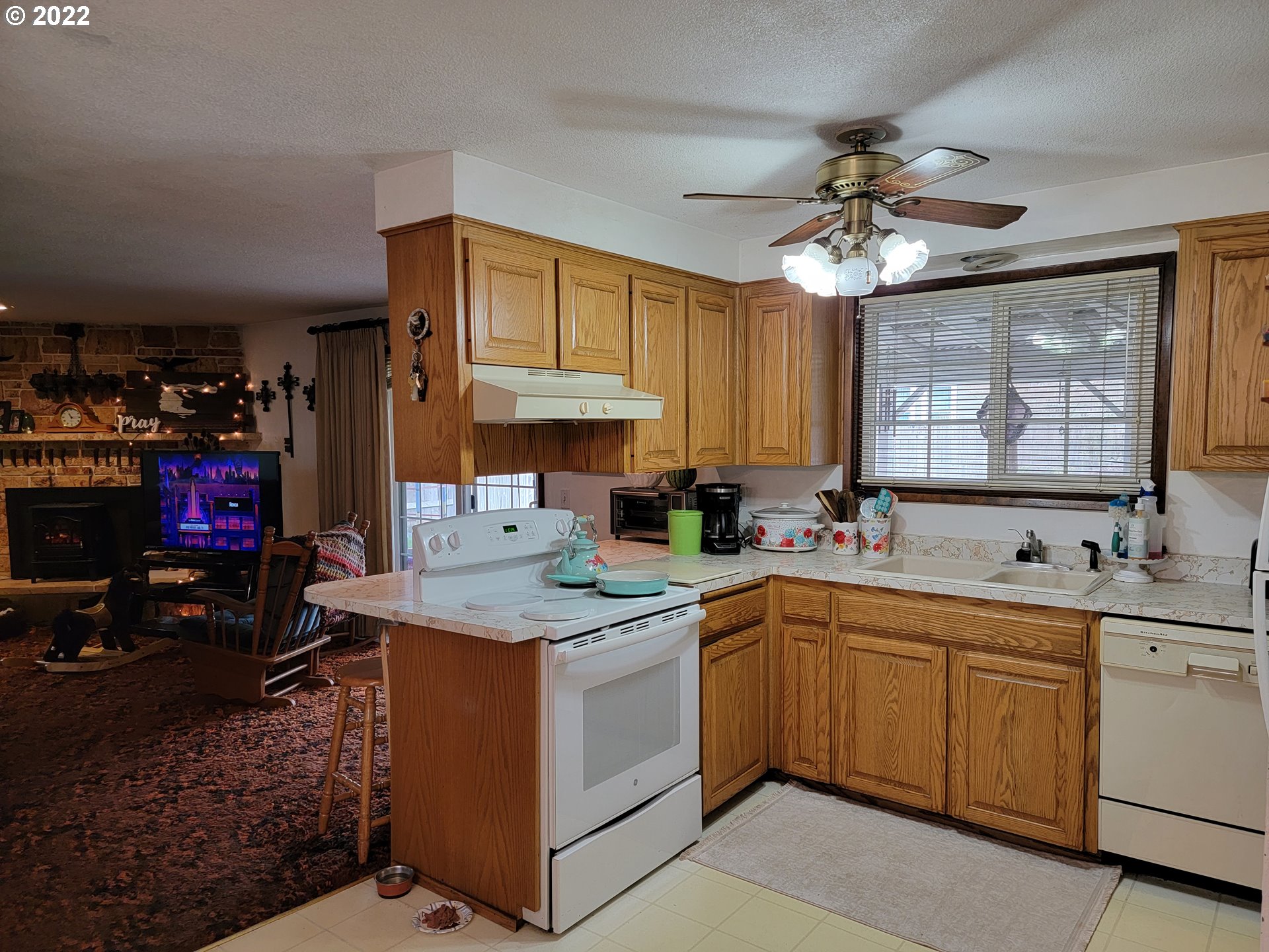 2287 8th Street Springfield, OR 97477 - Photo 4 of 18 a kitchen that has a sink a stove and cabinets