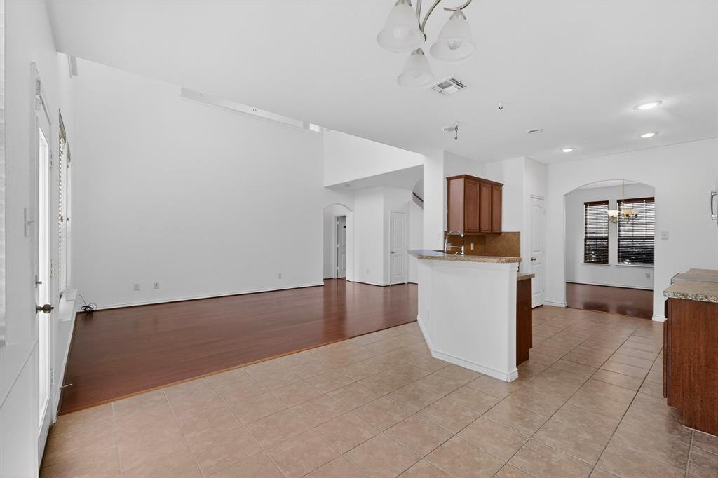426 Harding Lane Lavon, TX 75166 - Photo 14 of 40 Open-concept living area featuring high vaulted ceilings and a combination of tile and wood-finish flooring