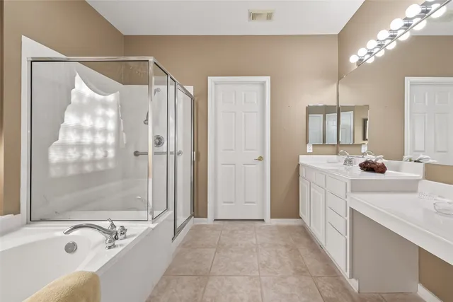 a bathroom with a tub sink and mirror