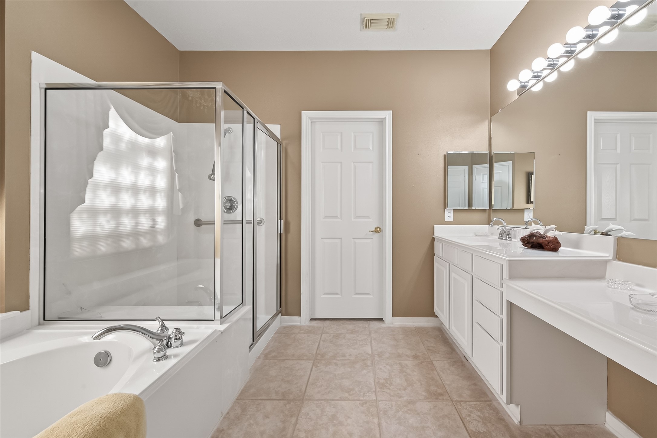 a bathroom with a tub sink and mirror