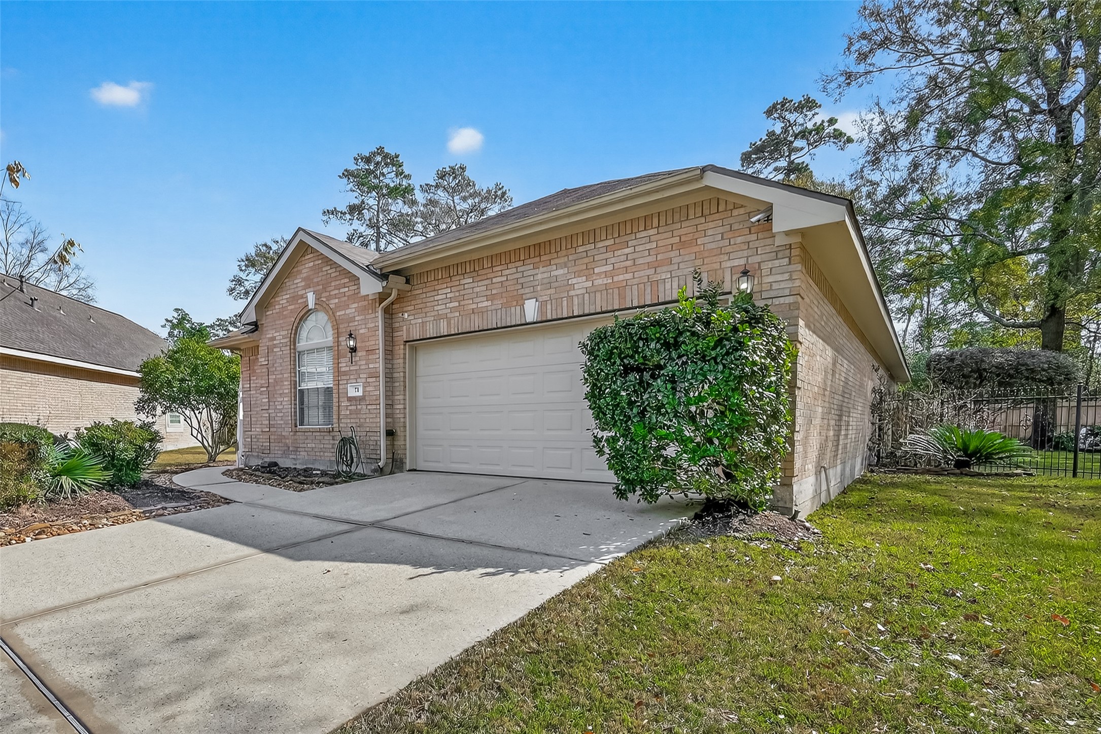 71 Ember Pines Court Conroe, TX 77384 - Photo 2 of 29 a front view of a house with garden