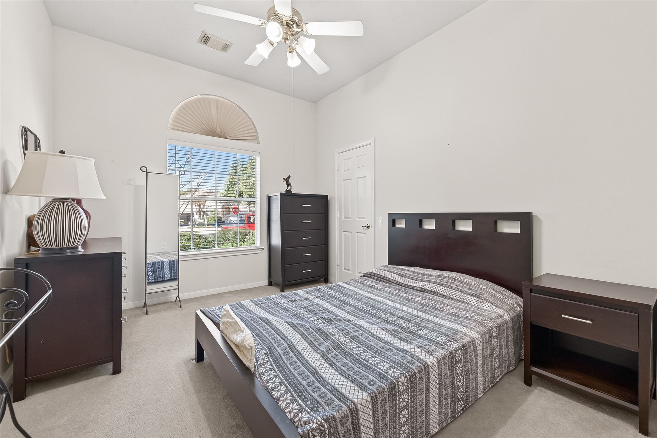 71 Ember Pines Court Conroe, TX 77384 - Photo 23 of 29 a bedroom with a bed and wooden floor
