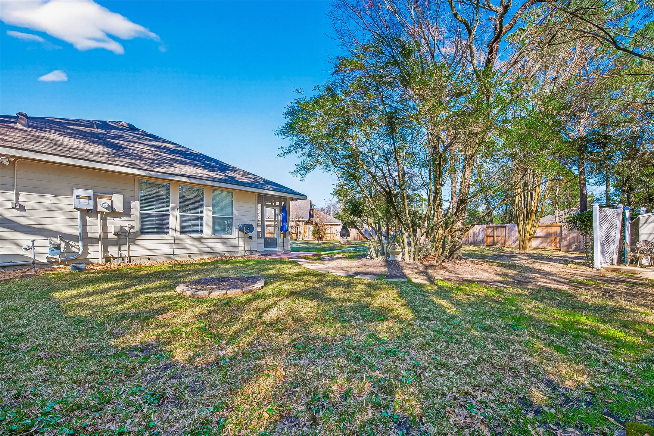 71 Ember Pines Court Conroe, TX 77384 - Photo 28 of 29 a view of a house with a yard