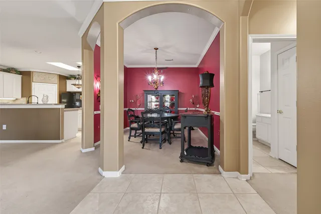 a view of a dining room with furniture and chandelier