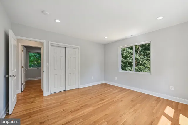 a view of an empty room with wooden floor