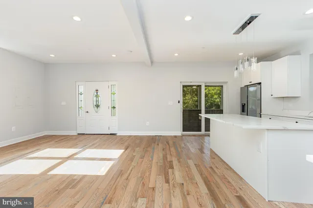 a kitchen with a sink cabinets and wooden floor