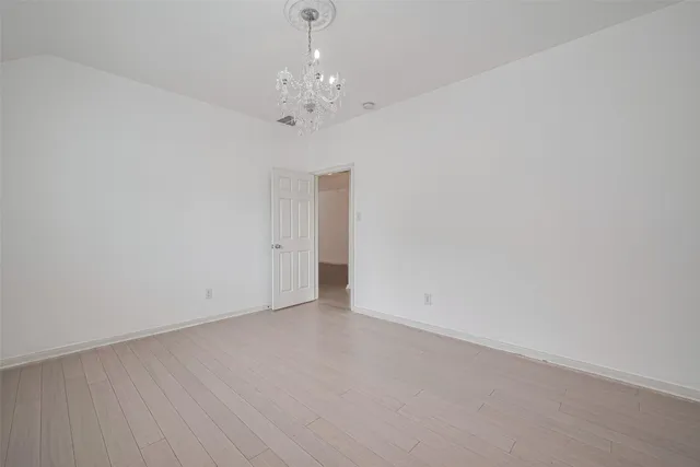 a view of an empty room with a chandelier