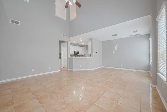 a view of a kitchen with a sink and a refrigerator