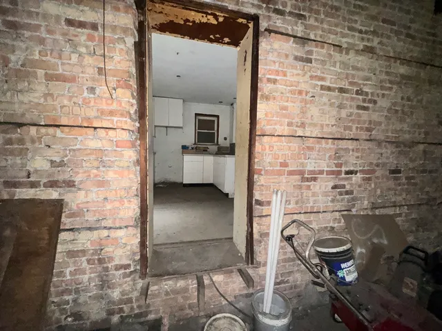 a large white kitchen with a stove a sink dishwasher and a refrigerator