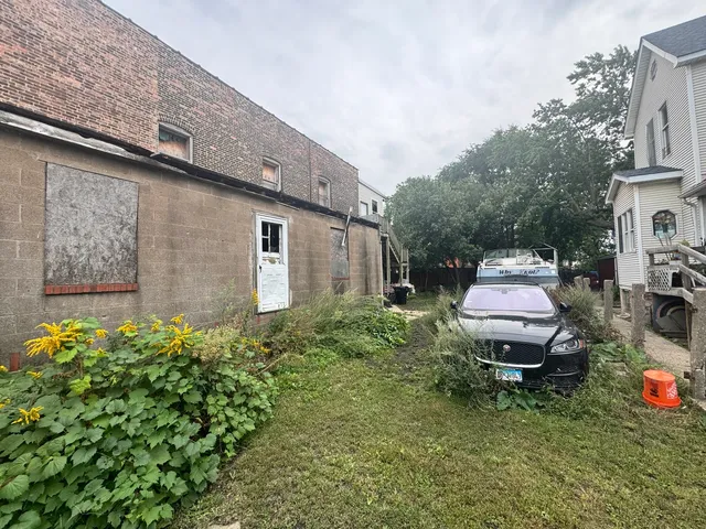 a backyard of a house with table and chairs