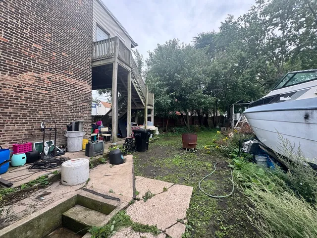 a view of a chairs and table in backyard