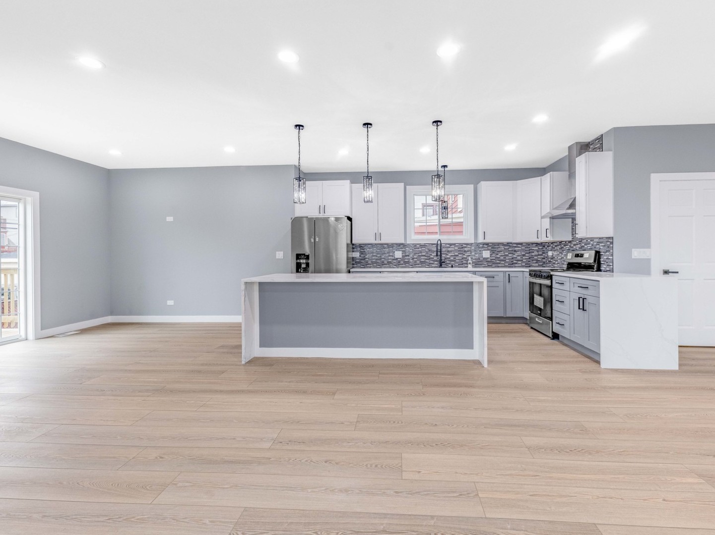 3548 Clinton Avenue Berwyn, IL 60402 - Photo 10 of 49 a large kitchen with kitchen island a large counter top stainless steel appliances and cabinets