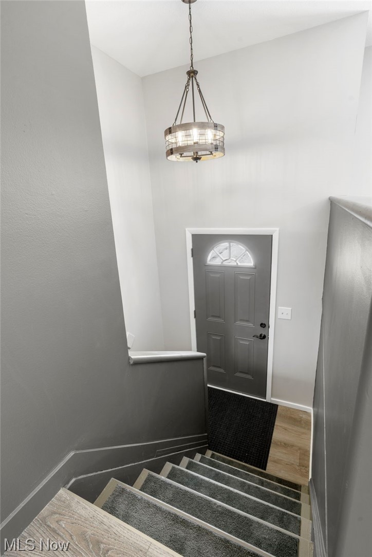 1655 Sunnyacres Road Akron, OH 44321 - Photo 5 of 30 Stairway with a chandelier and dark hardwood / wood-style flooring