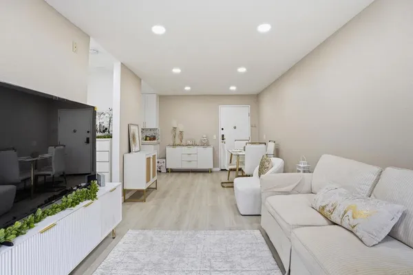 a living room with furniture and a large window