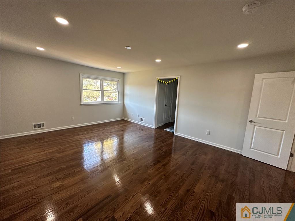 4102 Hana Road Edison, NJ 08817 - Photo 19 of 40 an empty room with wooden floor and windows