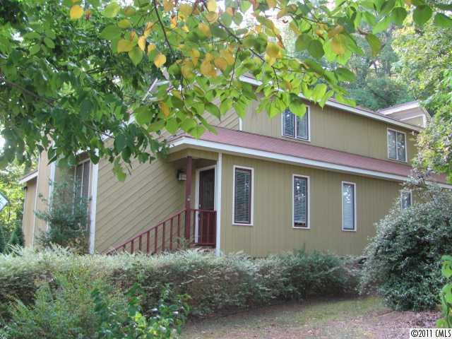 a front view of a house with plants