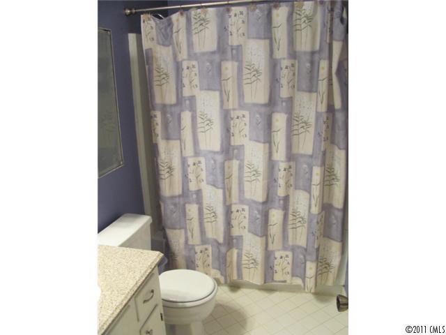 3800 Churchill Road, Unit 1 Charlotte, NC 28211 - Photo 13 of 16 a white toilet sitting next to a shower curtain